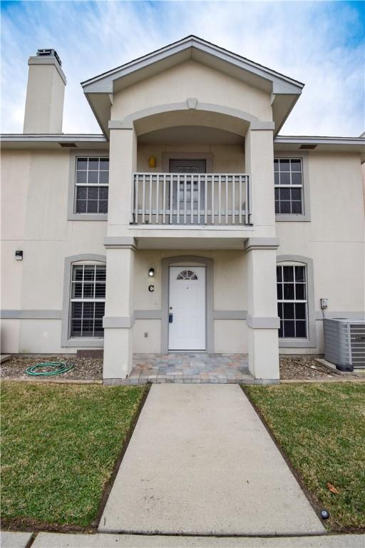 14435 Compass St Unit C, Corpus Christi, TX 78418 - view of front facade with a balcony, central AC unit, and stucco siding