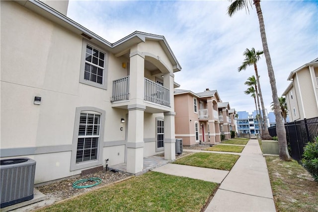14435 Compass St Unit C, Corpus Christi, TX 78418 - exterior space featuring central AC unit, stucco siding, a balcony, and a residential view