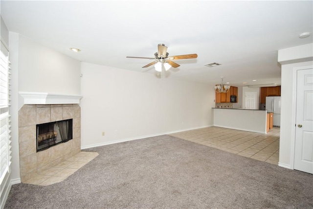 14435 Compass St Unit C, Corpus Christi, TX 78418 - unfurnished living room featuring light carpet, a ceiling fan, a tiled fireplace, baseboards, and recessed lighting