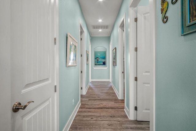 hallway with hardwood / wood-style flooring