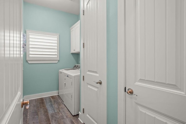 washroom with dark hardwood / wood-style flooring, cabinets, and washer and dryer