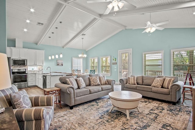 living room featuring sink, a wealth of natural light, high vaulted ceiling, and light hardwood / wood-style flooring