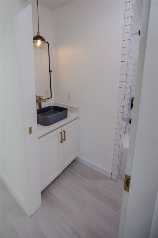 bathroom with vanity and hardwood / wood-style flooring