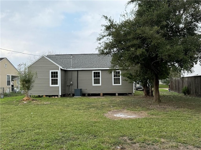 rear view of house featuring a yard and cooling unit