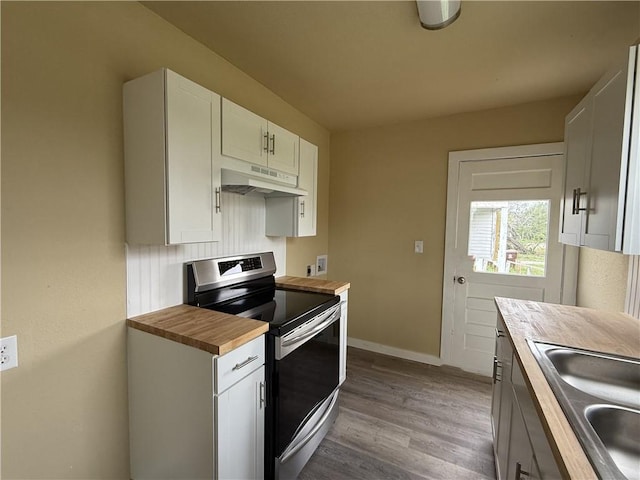 kitchen featuring sink, white cabinets, hardwood / wood-style floors, butcher block countertops, and stainless steel electric range