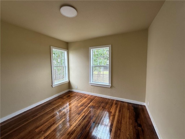 empty room with dark hardwood / wood-style floors