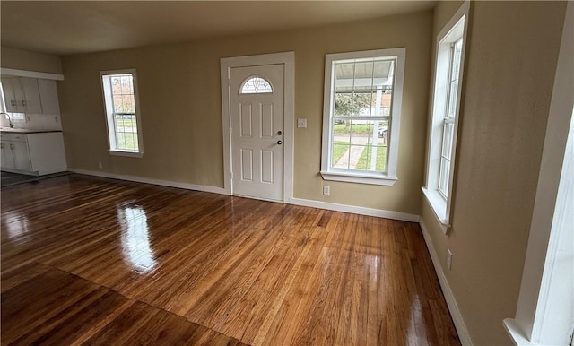 entryway with hardwood / wood-style floors and sink