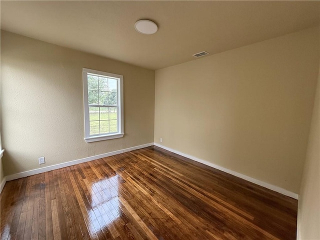 empty room featuring dark hardwood / wood-style floors