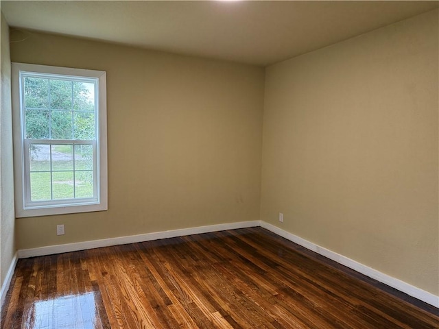 empty room with dark hardwood / wood-style floors