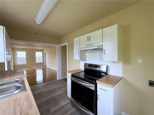 kitchen with stainless steel electric stove, dark hardwood / wood-style flooring, sink, and white cabinets