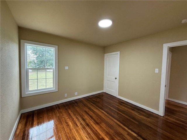 spare room featuring dark hardwood / wood-style floors