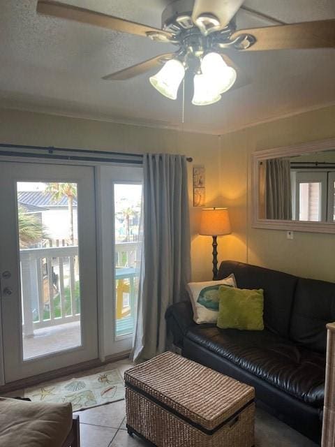 3938 Surfside Blvd Unit 1206, Corpus Christi, TX 78402 - tiled living room with healthy amount of natural light, a ceiling fan, and ornamental molding
