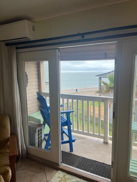 3938 Surfside Blvd Unit 1206, Corpus Christi, TX 78402 - doorway to outside featuring an AC wall unit, a water view, ornamental molding, and tile patterned floors
