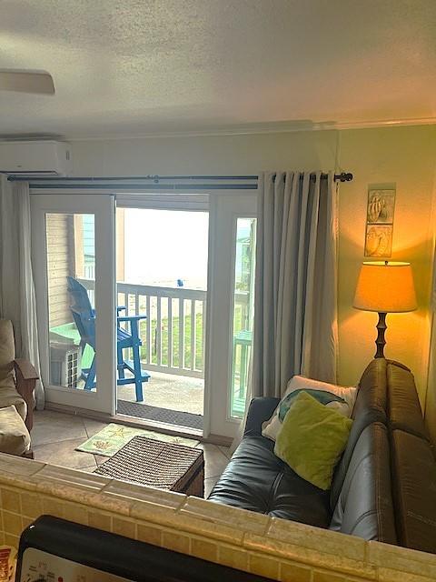 3938 Surfside Blvd Unit 1206, Corpus Christi, TX 78402 - living room featuring a wall mounted AC, healthy amount of natural light, a textured ceiling, and crown molding