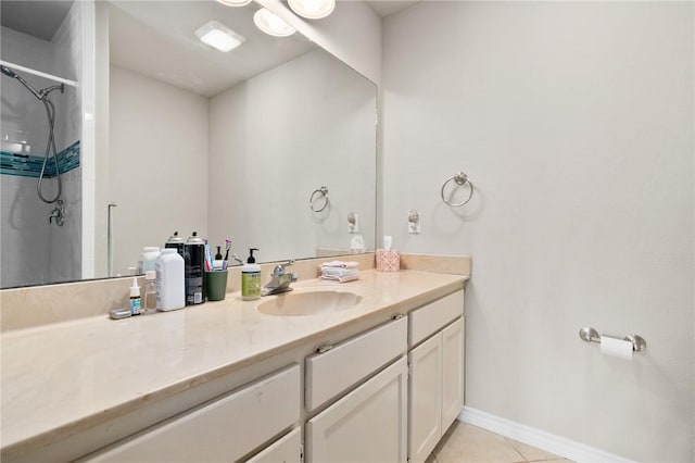 bathroom featuring tile patterned flooring, vanity, and a shower