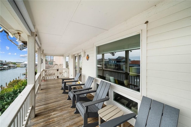 wooden terrace featuring a water view