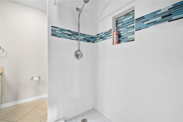 bathroom featuring tile patterned floors and a tile shower