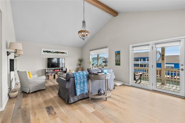 living room featuring plenty of natural light, beamed ceiling, hardwood / wood-style floors, and high vaulted ceiling