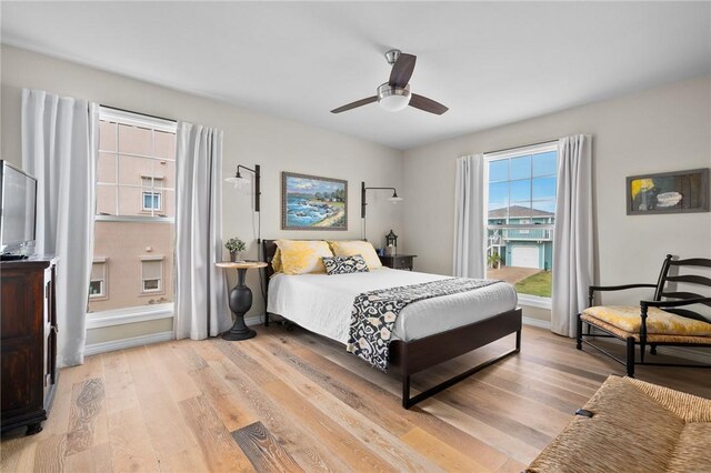 bedroom with light hardwood / wood-style floors and ceiling fan