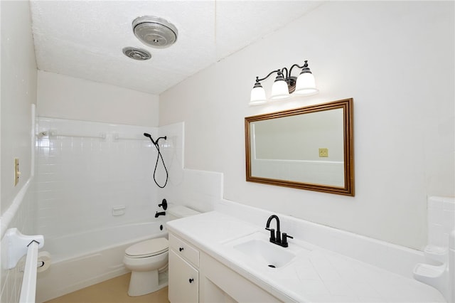 full bathroom with tiled shower / bath, a textured ceiling, toilet, and vanity