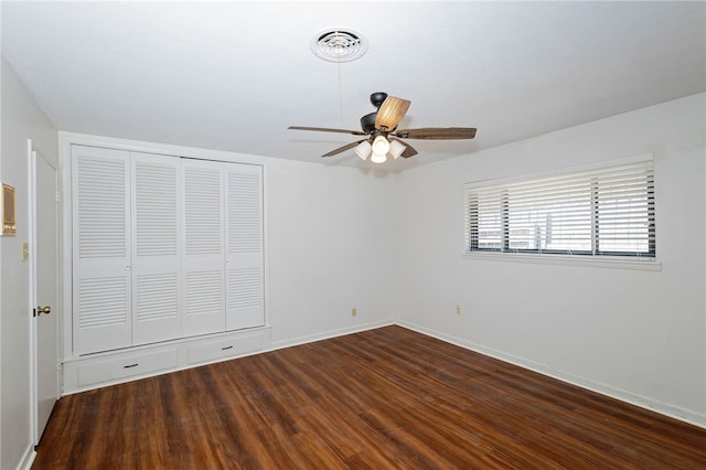 unfurnished bedroom with dark hardwood / wood-style flooring and ceiling fan