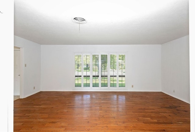 spare room with dark hardwood / wood-style flooring