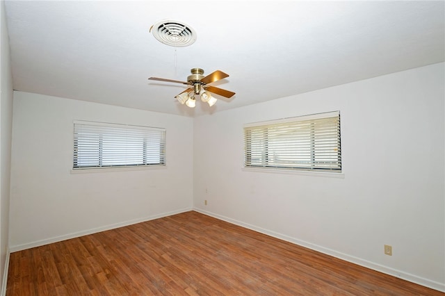 empty room with hardwood / wood-style floors and ceiling fan