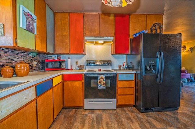 kitchen featuring black appliances, sink, decorative backsplash, and dark hardwood / wood-style floors