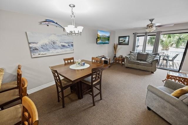 carpeted dining area featuring ceiling fan with notable chandelier