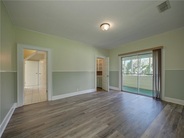 unfurnished room featuring hardwood / wood-style flooring