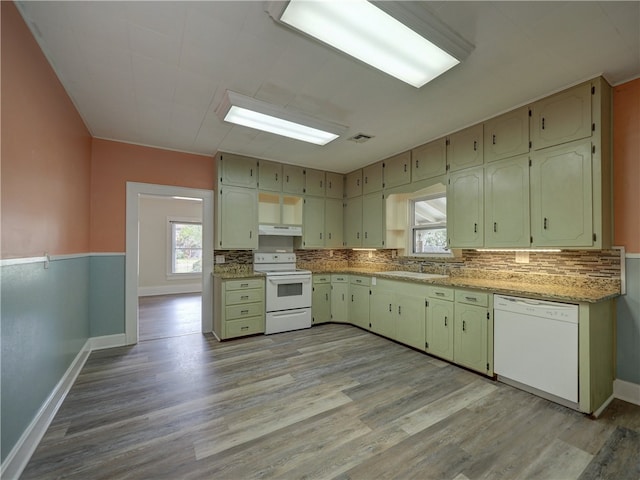 kitchen with white appliances, light hardwood / wood-style floors, light stone counters, and sink