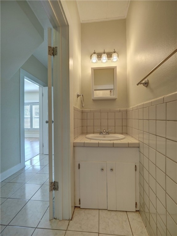 bathroom featuring vanity, tile patterned floors, and tile walls