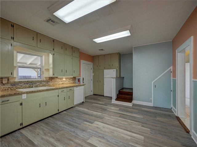 kitchen featuring light wood-type flooring, white appliances, and sink