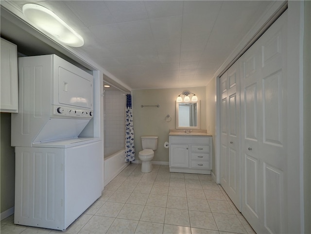 full bathroom with stacked washer / dryer, shower / tub combo with curtain, vanity, and tile patterned flooring