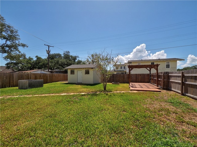 view of yard with a pergola, a wooden deck, and an outbuilding