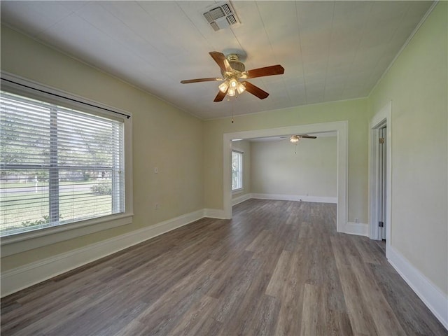 442 W Yoakum Ave, Aransas Pass, TX 78336 - unfurnished room with wood finished floors, ceiling fan, ornamental molding, and baseboards