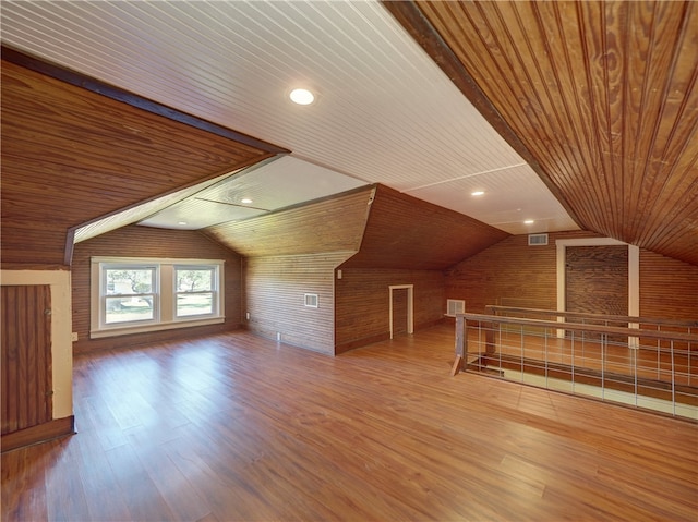 additional living space featuring hardwood / wood-style floors, wooden ceiling, and lofted ceiling