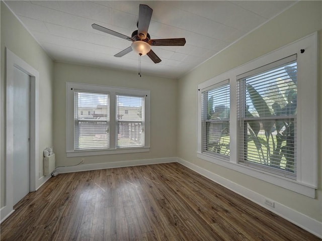 442 W Yoakum Ave, Aransas Pass, TX 78336 - empty room with healthy amount of natural light, dark wood finished floors, a ceiling fan, and baseboards