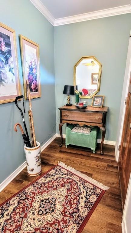 1017 Hickory Ave, Rockport, TX 78382 - hallway with wood finished floors, crown molding, and baseboards