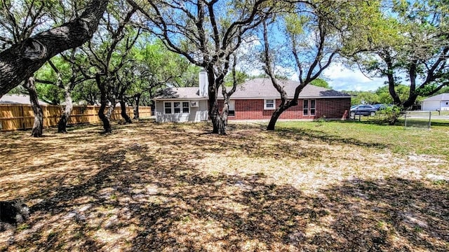 1017 Hickory Ave, Rockport, TX 78382 - view of front of house featuring a fenced backyard and a chimney