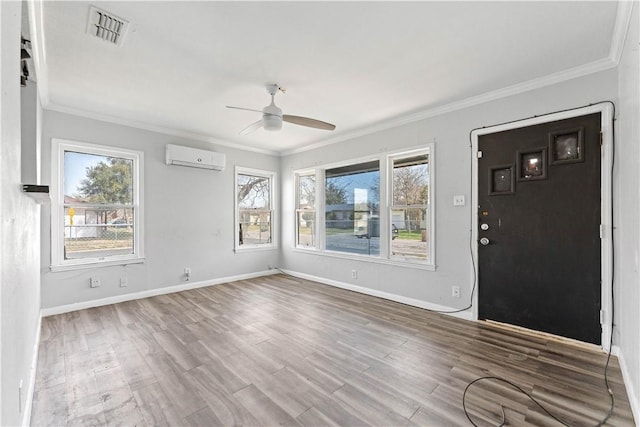 interior space featuring a wall unit AC, crown molding, visible vents, and wood finished floors