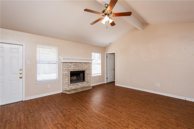 unfurnished living room featuring a wealth of natural light, a ceiling fan, wood finished floors, and vaulted ceiling with beams