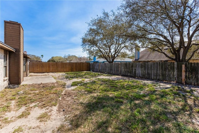 view of yard featuring a patio and a fenced backyard