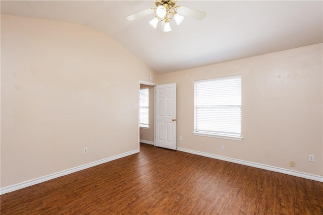 spare room with dark wood-style floors, baseboards, lofted ceiling, and a ceiling fan