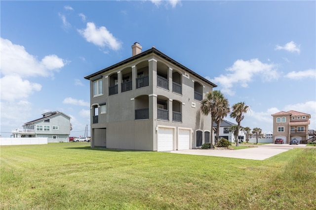 exterior space with a garage, a lawn, and a balcony