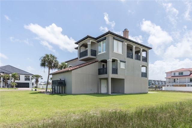 back of property featuring a lawn