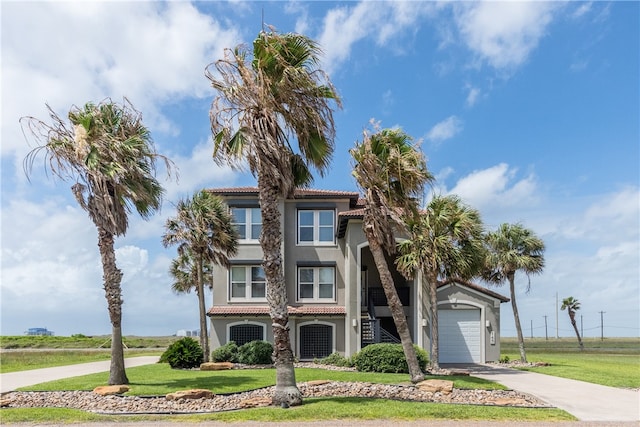 145 Mariners Dr, Port Aransas, TX 78373 - view of front of home with a garage and a front yard