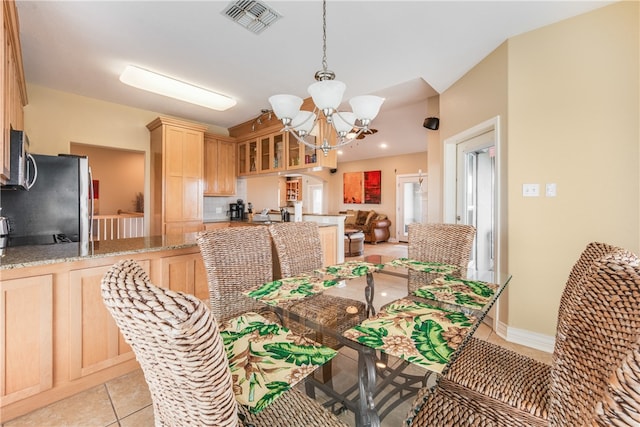 tiled dining area with a notable chandelier