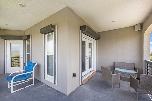 balcony featuring a patio and french doors