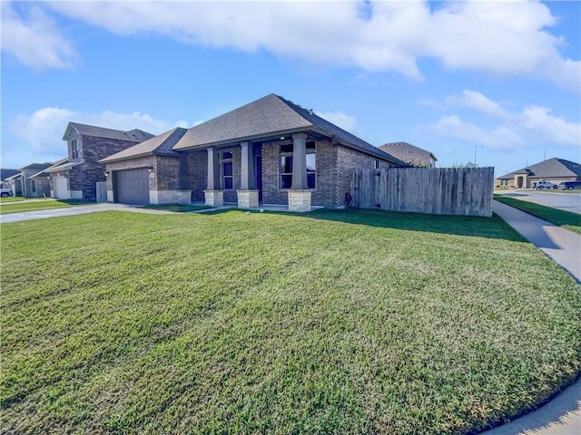 view of front of property featuring a front yard and a garage